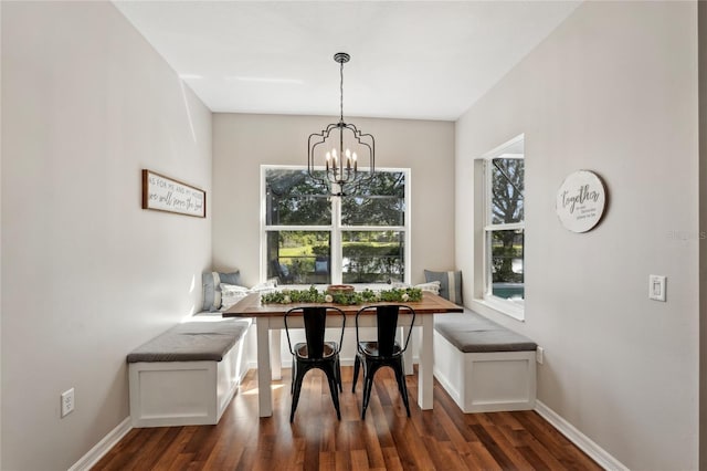 5023 Brickell Park Cv, Bradenton, FL 34211 - dining room featuring breakfast area, dark wood-style flooring, a chandelier, and baseboards