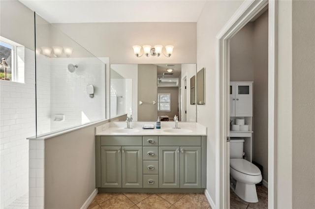 5023 Brickell Park Cv, Bradenton, FL 34211 - full bath with walk in shower, double vanity, toilet, tile patterned flooring, and baseboards
