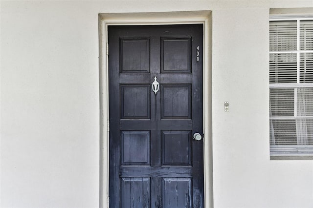 7461 W Country Club Dr N Unit 408, Sarasota, FL 34243 - view of exterior entry with stucco siding