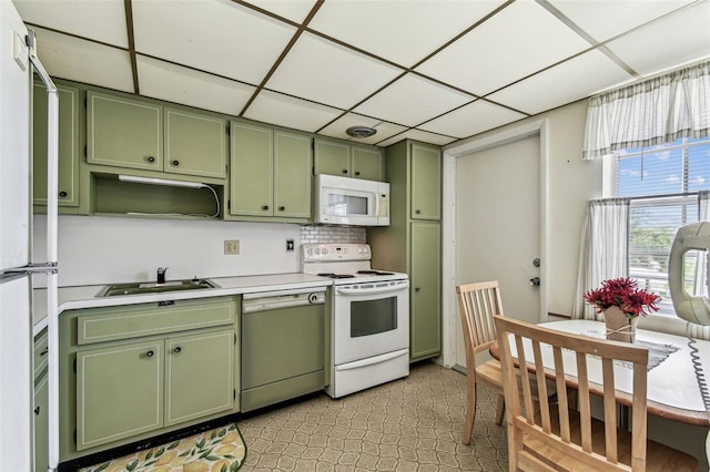 7461 W Country Club Dr N Unit 408, Sarasota, FL 34243 - kitchen with white appliances, green cabinets, light countertops, and a sink