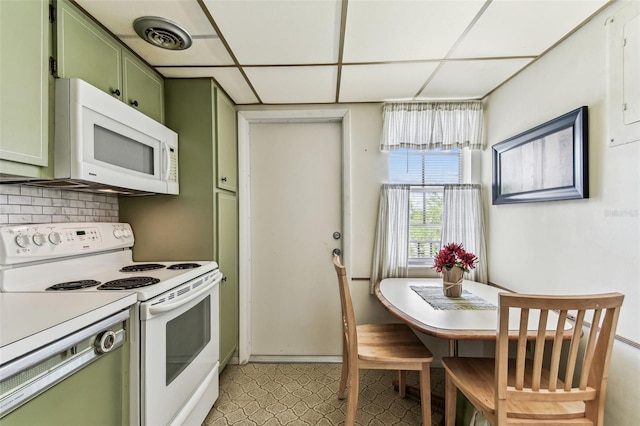 7461 W Country Club Dr N Unit 408, Sarasota, FL 34243 - kitchen featuring green cabinets, white appliances, visible vents, decorative backsplash, and a drop ceiling