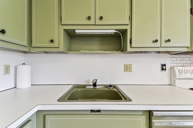 7461 W Country Club Dr N Unit 408, Sarasota, FL 34243 - kitchen with green cabinets, backsplash, light countertops, and a sink