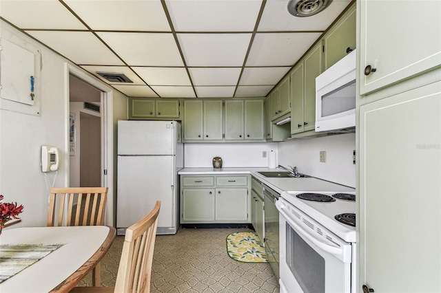 7461 W Country Club Dr N Unit 408, Sarasota, FL 34243 - kitchen featuring a paneled ceiling, white appliances, visible vents, a sink, and green cabinetry