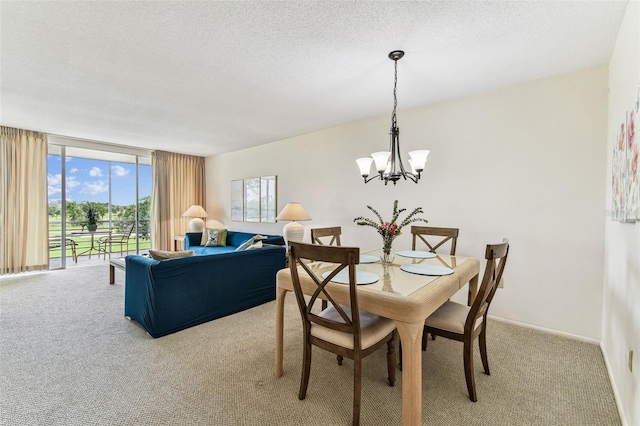 7461 W Country Club Dr N Unit 408, Sarasota, FL 34243 - dining space featuring a textured ceiling, light colored carpet, a notable chandelier, and expansive windows