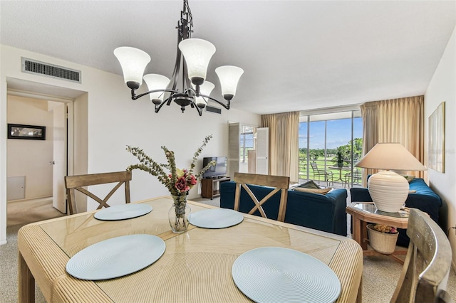 7461 W Country Club Dr N Unit 408, Sarasota, FL 34243 - dining space featuring visible vents, an inviting chandelier, and carpet floors