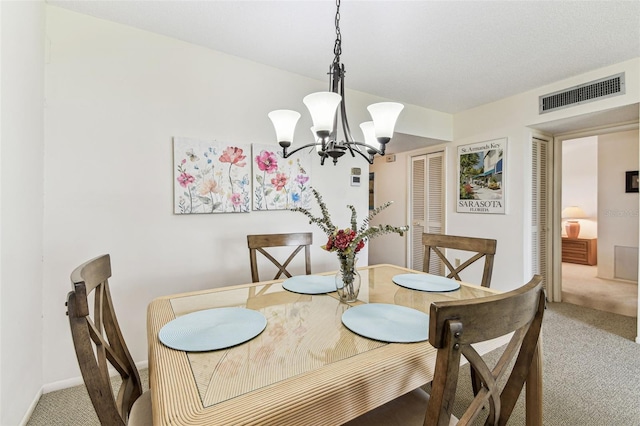 7461 W Country Club Dr N Unit 408, Sarasota, FL 34243 - dining room featuring a chandelier, baseboards, visible vents, and carpet floors