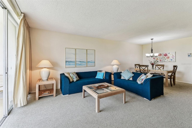 7461 W Country Club Dr N Unit 408, Sarasota, FL 34243 - carpeted living room featuring a textured ceiling, an inviting chandelier, and a healthy amount of sunlight