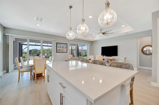 27061 Paradise Shores Dr, Englewood, FL 34223 - kitchen with ceiling fan, recessed lighting, white cabinetry, baseboards, and light countertops