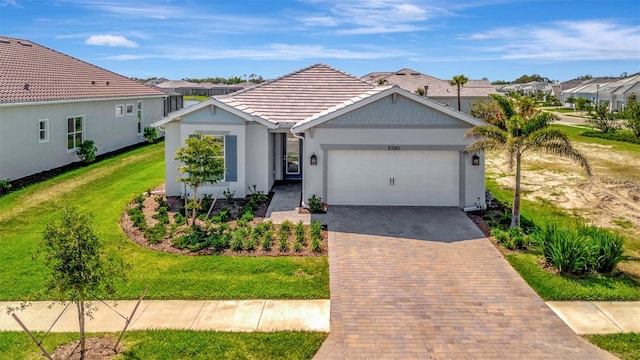 27061 Paradise Shores Dr, Englewood, FL 34223 - single story home with a tiled roof, a garage, decorative driveway, stucco siding, and a front yard