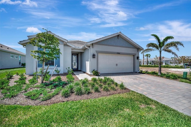 27061 Paradise Shores Dr, Englewood, FL 34223 - single story home with a garage, stucco siding, and decorative driveway