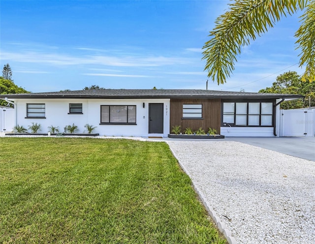 1921 Fern Ave, Sarasota, FL 34235 - view of front of property with stucco siding, fence, and a front lawn
