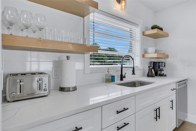 1921 Fern Ave, Sarasota, FL 34235 - kitchen with a sink, open shelves, a toaster, white cabinetry, and stainless steel dishwasher