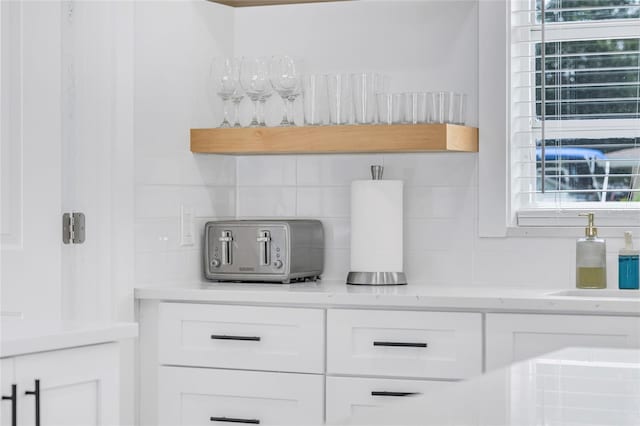 1921 Fern Ave, Sarasota, FL 34235 - interior details with white cabinetry, decorative backsplash, light countertops, and a toaster