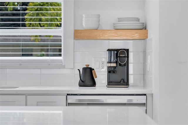 1921 Fern Ave, Sarasota, FL 34235 - details with light stone countertops, white cabinets, and dishwasher