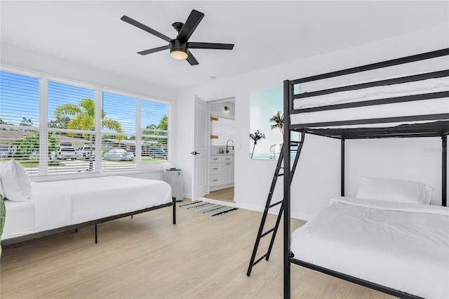 1921 Fern Ave, Sarasota, FL 34235 - bedroom with a sink, baseboards, a ceiling fan, and light wood-style floors