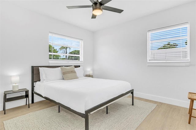 1921 Fern Ave, Sarasota, FL 34235 - bedroom with light wood-style flooring, baseboards, and ceiling fan