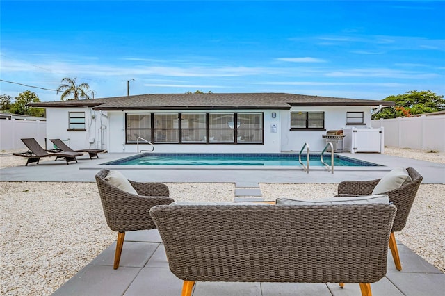 1921 Fern Ave, Sarasota, FL 34235 - rear view of property featuring a patio area, a fenced in pool, and a fenced backyard