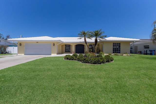 508 70th St, Holmes Beach, FL 34217 - single story home featuring a front yard, a garage, concrete driveway, a tile roof, and stucco siding