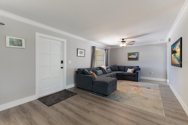 508 70th St, Holmes Beach, FL 34217 - living room featuring crown molding, baseboards, light wood-type flooring, and a ceiling fan