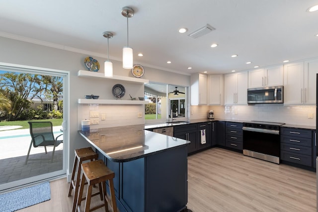508 70th St, Holmes Beach, FL 34217 - kitchen featuring a sink, visible vents, white cabinets, and appliances with stainless steel finishes