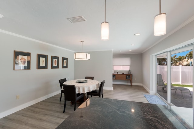 508 70th St, Holmes Beach, FL 34217 - dining area featuring light wood-style floors, visible vents, and ornamental molding