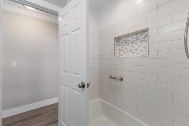 508 70th St, Holmes Beach, FL 34217 - bathroom with baseboards, walk in shower, crown molding, a bath, and wood finished floors