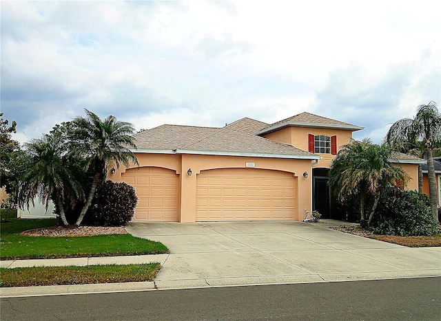 6631 63rd Ter E, Bradenton, FL 34203 - view of front of house featuring an attached garage, stucco siding, and driveway