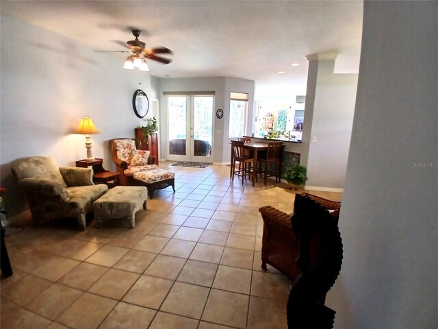 6631 63rd Ter E, Bradenton, FL 34203 - living area with light tile patterned floors, a ceiling fan, french doors, and baseboards