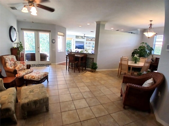 6631 63rd Ter E, Bradenton, FL 34203 - living area featuring light tile patterned floors, a ceiling fan, healthy amount of natural light, baseboards, and recessed lighting