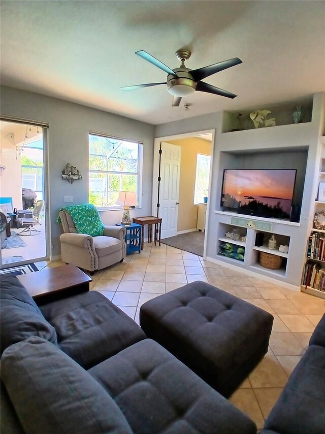 6631 63rd Ter E, Bradenton, FL 34203 - tiled living area featuring plenty of natural light, ceiling fan, built in shelves, and baseboards