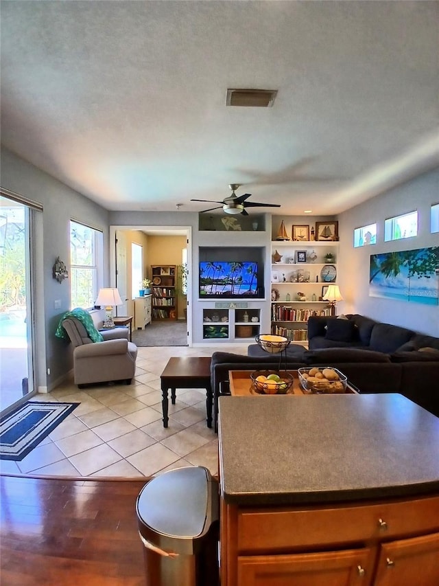 6631 63rd Ter E, Bradenton, FL 34203 - living room featuring ceiling fan and light tile patterned flooring
