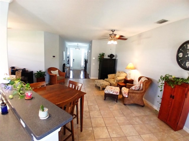 6631 63rd Ter E, Bradenton, FL 34203 - dining area with light tile patterned floors, a ceiling fan, and baseboards