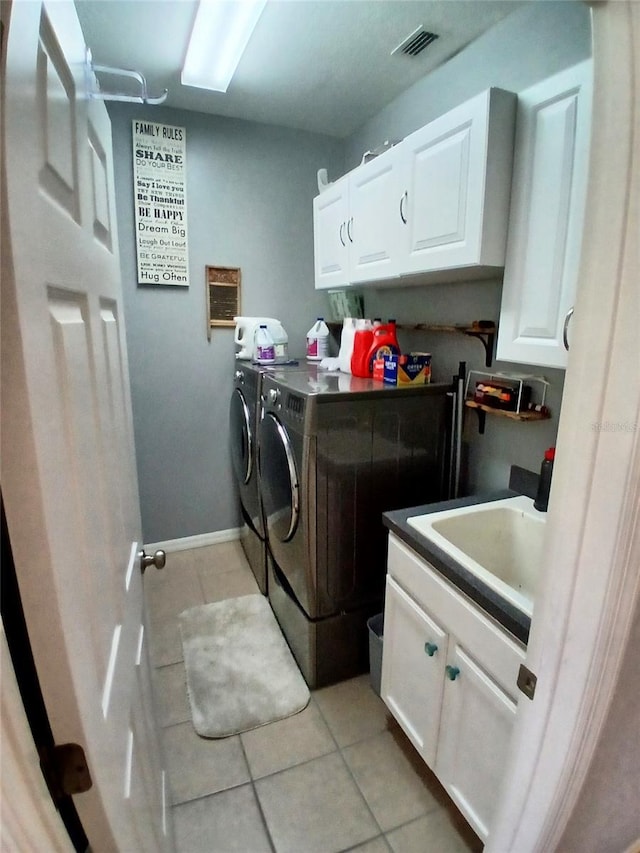 6631 63rd Ter E, Bradenton, FL 34203 - washroom with washing machine and clothes dryer, cabinet space, and light tile patterned floors