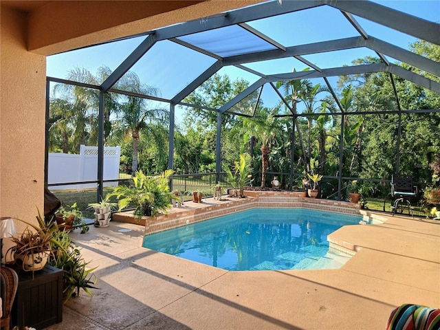 6631 63rd Ter E, Bradenton, FL 34203 - view of swimming pool with a patio area, glass enclosure, view of wooded area, and a fenced backyard