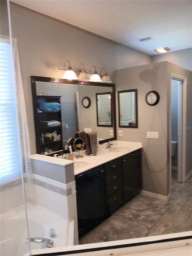 6631 63rd Ter E, Bradenton, FL 34203 - bathroom featuring a bathtub and double vanity
