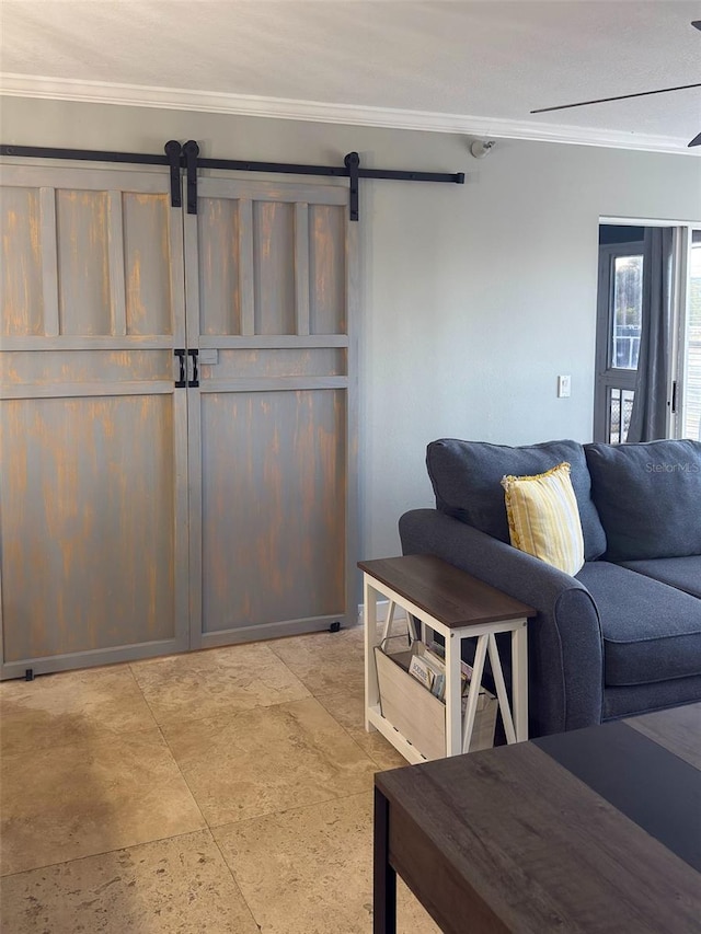 living room with crown molding and a barn door