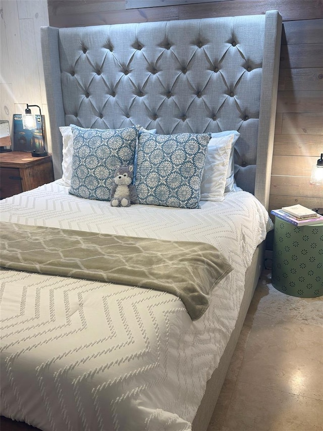 bedroom with wood walls