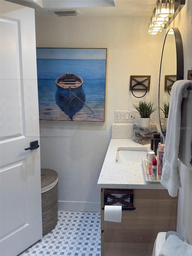 bathroom with tile patterned floors, vanity, and baseboards