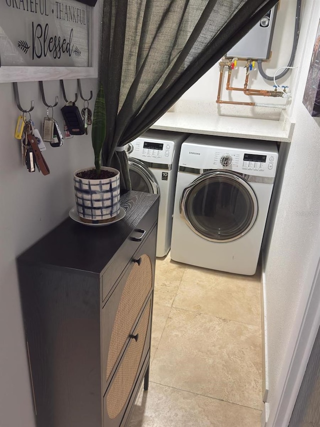 clothes washing area featuring laundry area and washing machine and clothes dryer