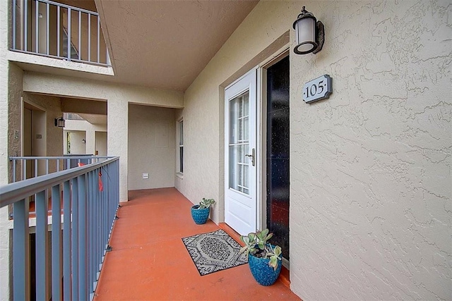 view of exterior entry with stucco siding