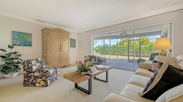 carpeted living room featuring visible vents, ornamental molding, and a textured ceiling