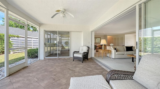 sunroom featuring ceiling fan
