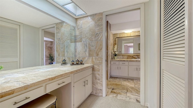 bathroom featuring a closet and vanity