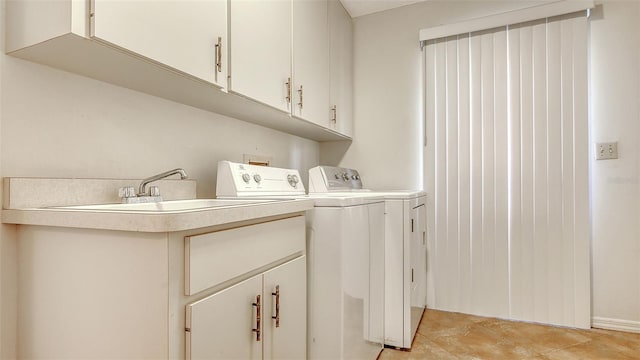 laundry room with washing machine and dryer and cabinet space