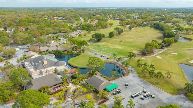 aerial view with golf course view and a water view