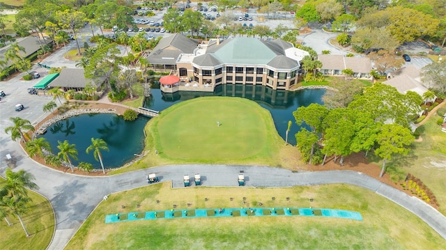 bird's eye view with golf course view, a water view, and a residential view
