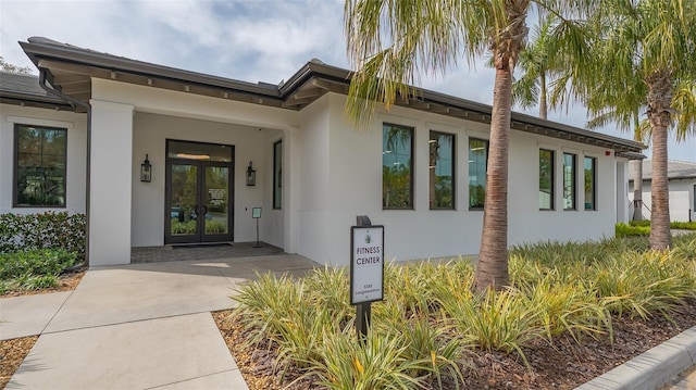 entrance to property with stucco siding and french doors