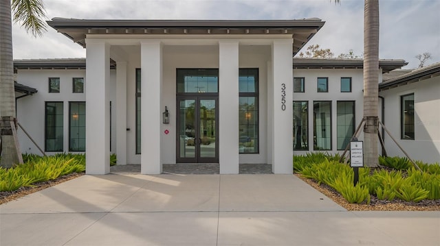 doorway to property with stucco siding and french doors