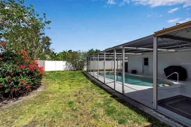 view of yard with glass enclosure, a fenced in pool, a fenced backyard, and a patio area