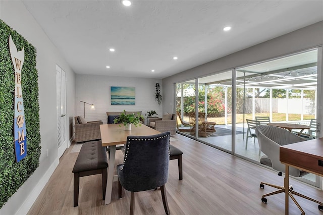 dining room with recessed lighting, baseboards, and light wood finished floors